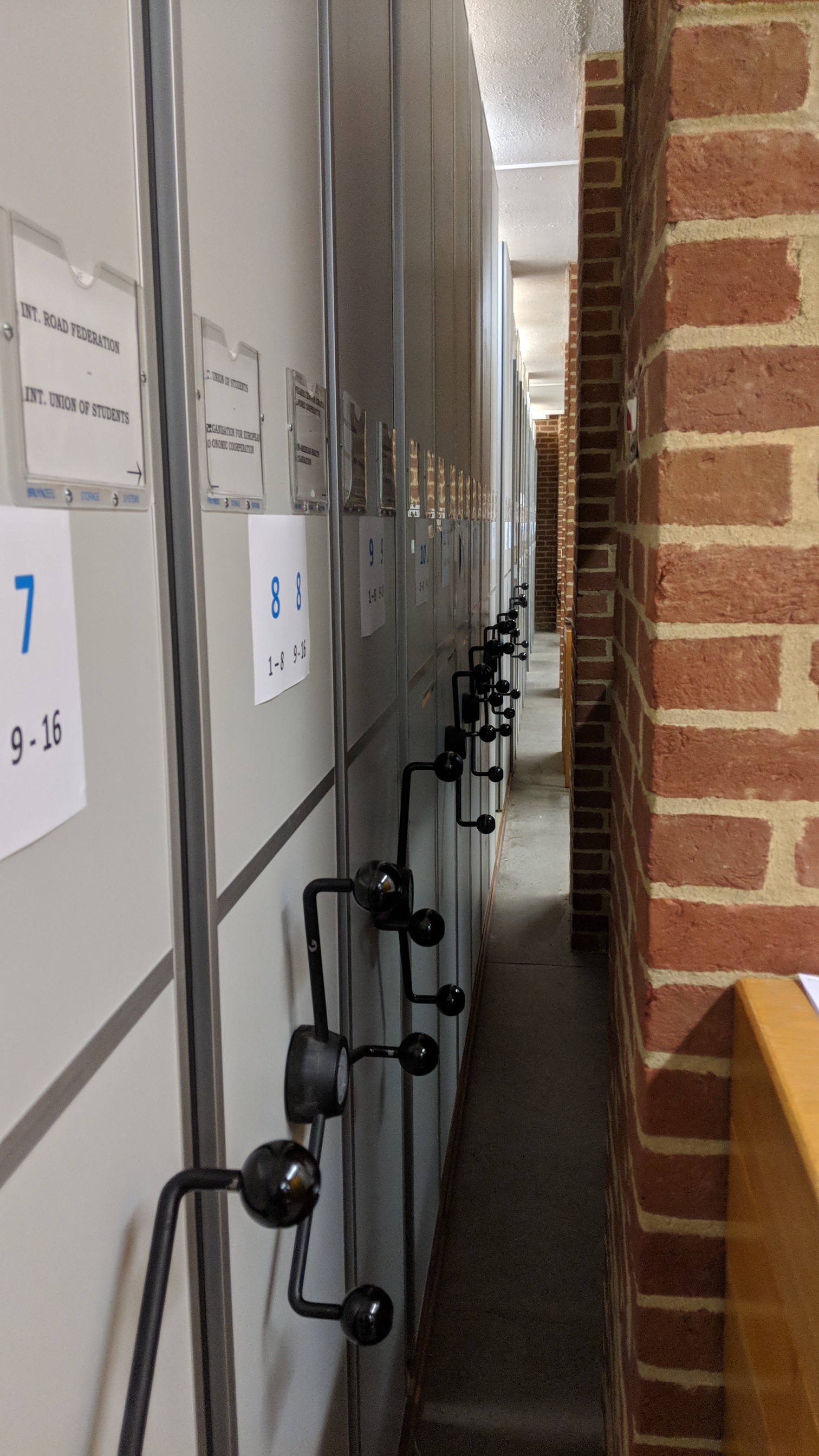 Side view of old BLDS stacks closed and right up against red brick pillars